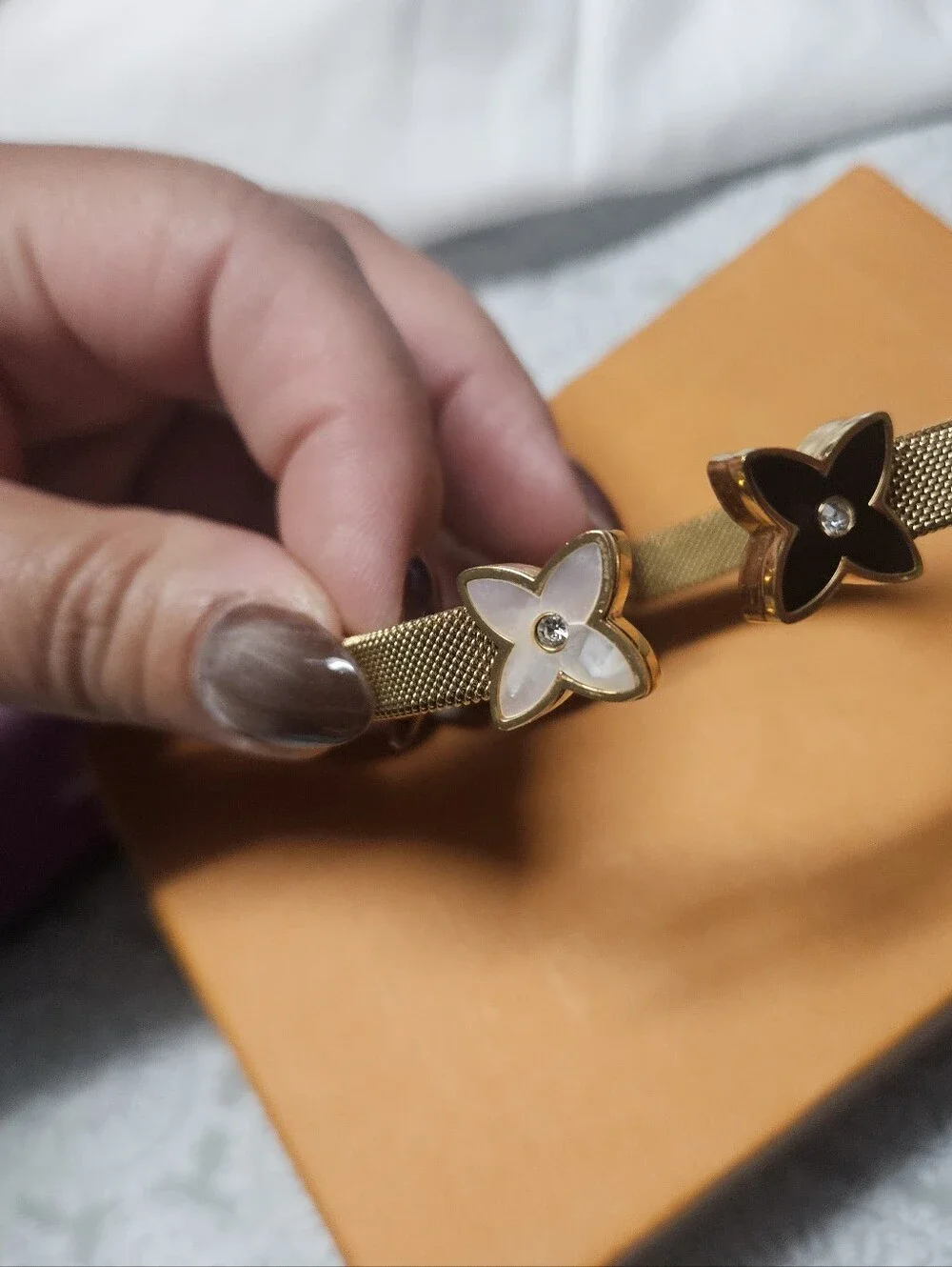 Gold Mesh Bracelet with Black and White Flower Charms